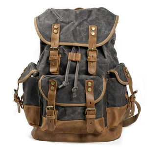 Mochila vintage de lona y cuero con múltiples bolsillos para hombre