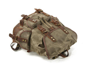 Mochila vintage de lona y cuero con múltiples bolsillos para hombre