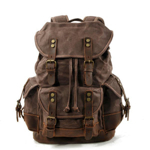 Mochila vintage de lona y cuero con múltiples bolsillos para hombre