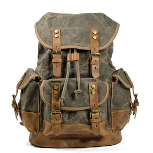 Mochila vintage de lona y cuero con múltiples bolsillos para hombre