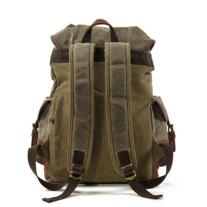 Mochila vintage de lona y cuero con múltiples bolsillos para hombre