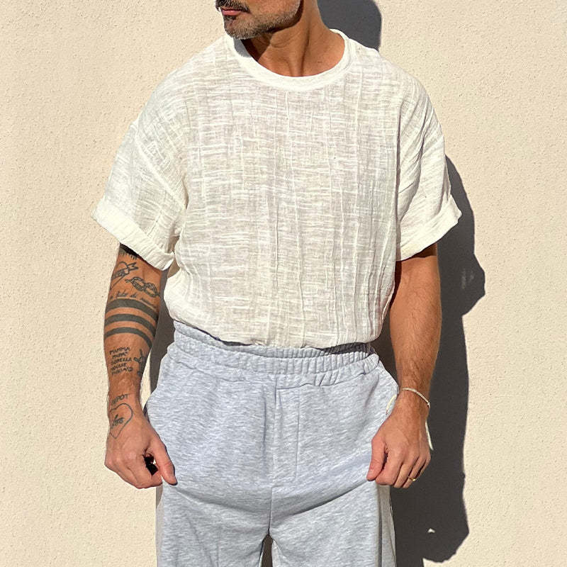 Camiseta de manga corta con cuello redondo y textura de color liso para hombre