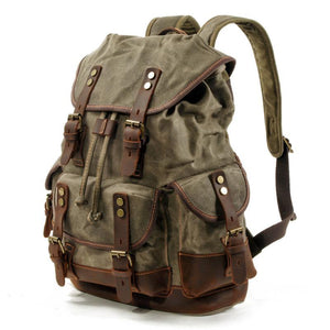 Mochila vintage de lona y cuero con múltiples bolsillos para hombre